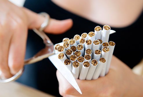 getty rm photo of woman cutting cigarettes with scissors