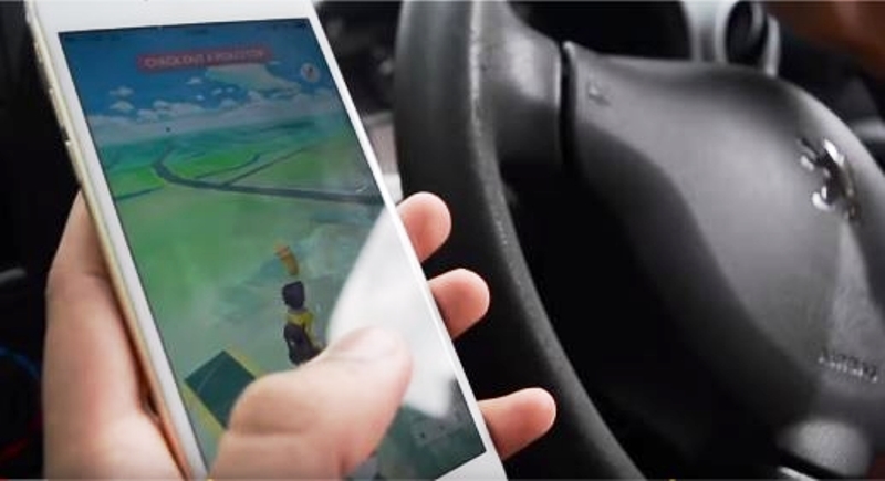 a player plays pokemon go in his car